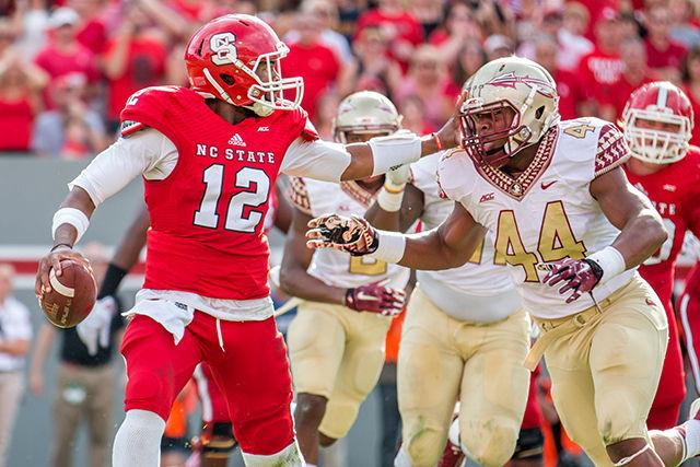 Redshirt Junior Quarterback Jacoby Brissett throws an 8 yard touchdown pass to Johnathan Alston during the game against No. 1 Florida State in Carter-Finley Stadium Saturday, Sept. 27, 2014. Despite a strong start, the Wolfpack fell to the Seminoles, 56-41. Photo by Ben Salama.