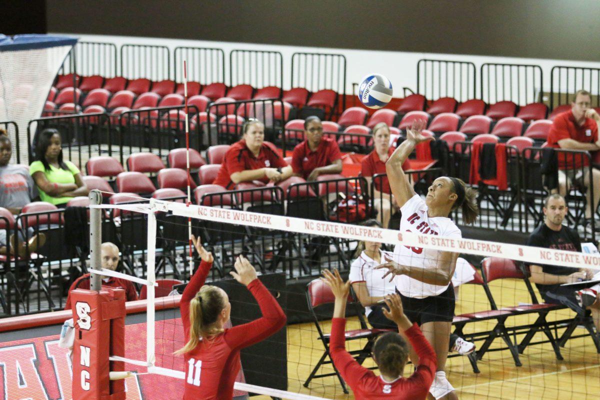 Senior outside hitter, Dariyan Hopper prepares to hit the ball past freshman teammate, outside hitter, Julia Brown Friday, August 22, 2014. The team scrimmaged and changed teams after each set in Reynolds Coliseum. Photo by Sam Whitlock.