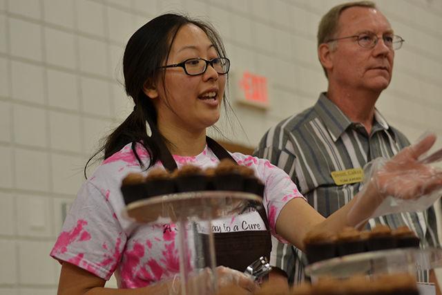 Jessica Yin, a sophomore in statistics, and Tom Jorden from Sweet Cakes bakery distribute chocolate at their booth during the Chocolate Festival on Friday. The Chocolate Festival aimed to raise breast cancer awareness.&#160;