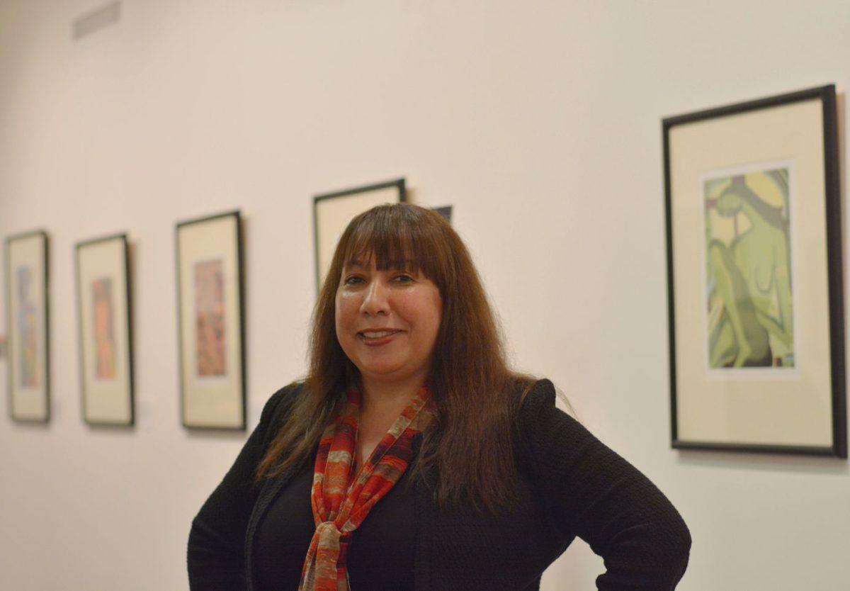 Soraida Martinez, artist and motivational speaker, stands in front of her exhibit in the African American Cultural Center in Witherspoon Student Center.