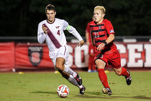 Freshman attacking midfielder Zach Knudson races towards goal against a Virginia Tech defender. Knudson scored one goal in the Pack&#8217;s 3-2 defeat to the Hokies.