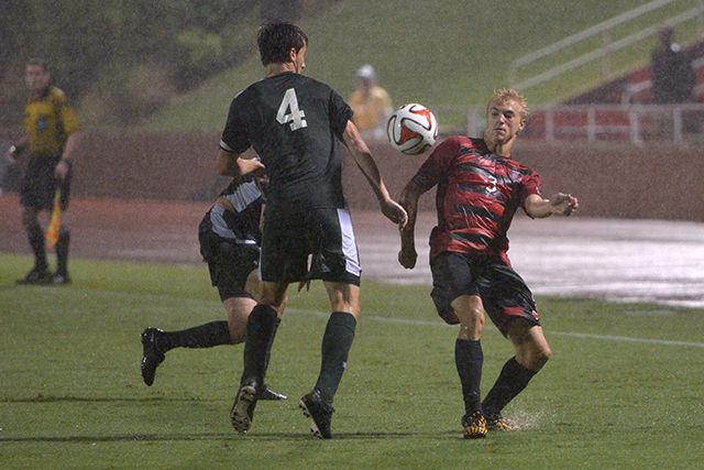 Freshman left defender Caleb Duvernay stands up against two William &amp; Mary attackers in the rain.&#160; NC State went on to win 1-0 against the Tribe on Monday at Dail Soccer Field.
