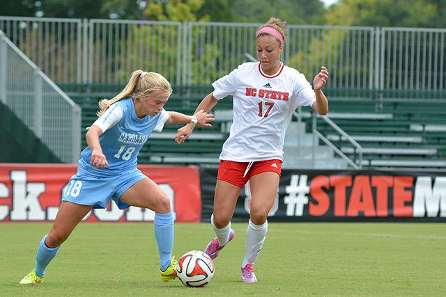Sophomore forward Gladys Loyas fights for posession of the ball during the women's soccer game against North Carolina at Dail Soccer Stadium Sunday, Sept. 28, 2014. The Tar Heels defeated the Wolfpack, 2-1. Photo by John Joyner.