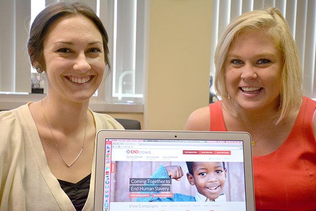 Joanna Foss, a part-time worker for the Institute for Nonprofits with the College of Humanities And Social Sciences and Caitlyn West, an NC State alumnus majoring in public relations, pose with the newly launched ENDcrowd website on a laptop. &#160;