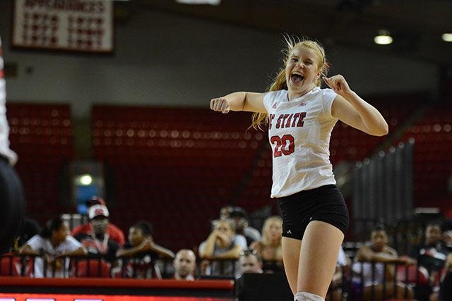 Cheering in excitement, sophomore defence specialist Maddie Brown helped her side score on the red. The team hosted a red verse white game to kick off the new season Friday, Aug 22, 2014. Photo by Joseph Phillips