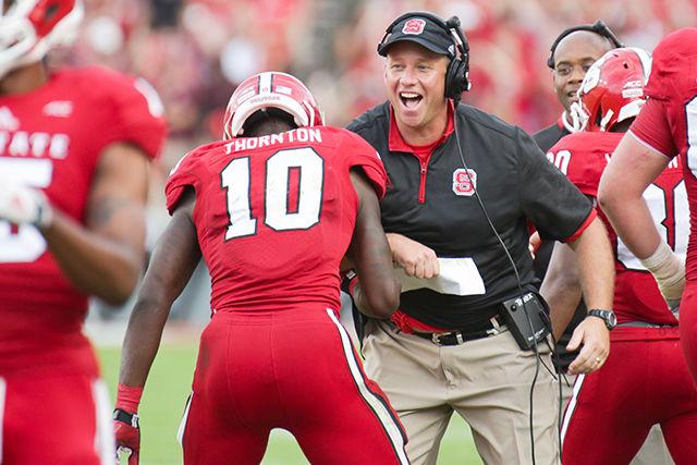 Junior running back Shadrach Thorton celebrates a touchdown run with Head Coach Dave Doeren. Though the Wolfpack had 500 yards of offense, FSU pulled off the win 56-41 on Saturday.