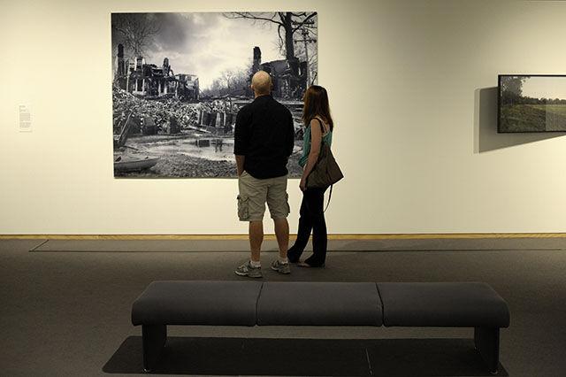 Museum visitors look at a piece from Private Eye, Allen Thomas Jr.'s photography collection shown at the N.C. Museum of Art in Raleigh. The collection went on exhibition Saturday.