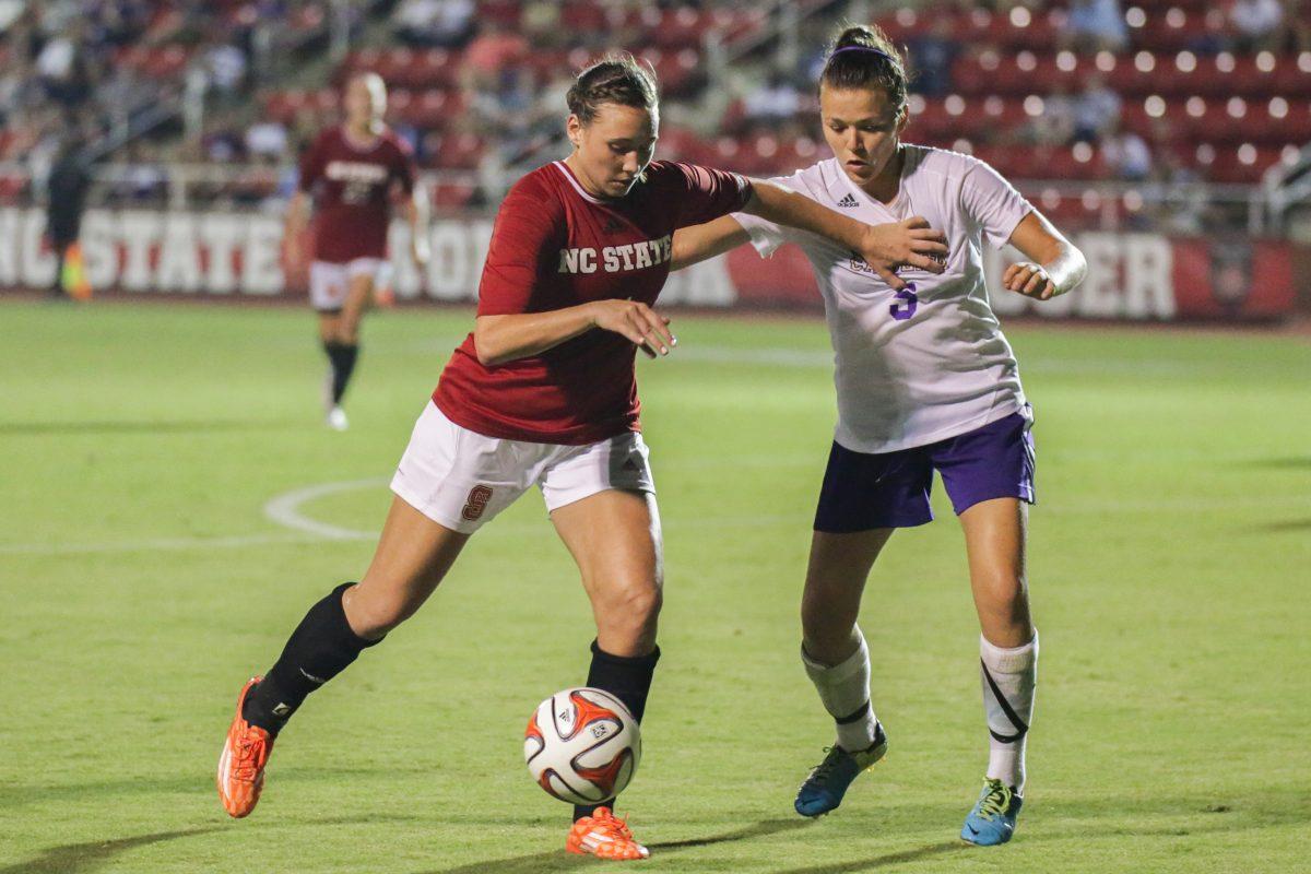 Freshman forward Kayla Saager presses the ball forward by pushing past Western Carolina defense. The Wolfpack tied Western Carolina 1-1 on September 11th, 2014.