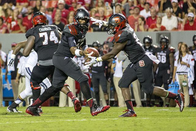 Redshirt junior quarterback Jacoby Brissett hands the football off to sophomore running back Matt Dayes during the second quarter against Old Dominion Sept. 6. The Wolfpack defeated the Monarchs 46-34.