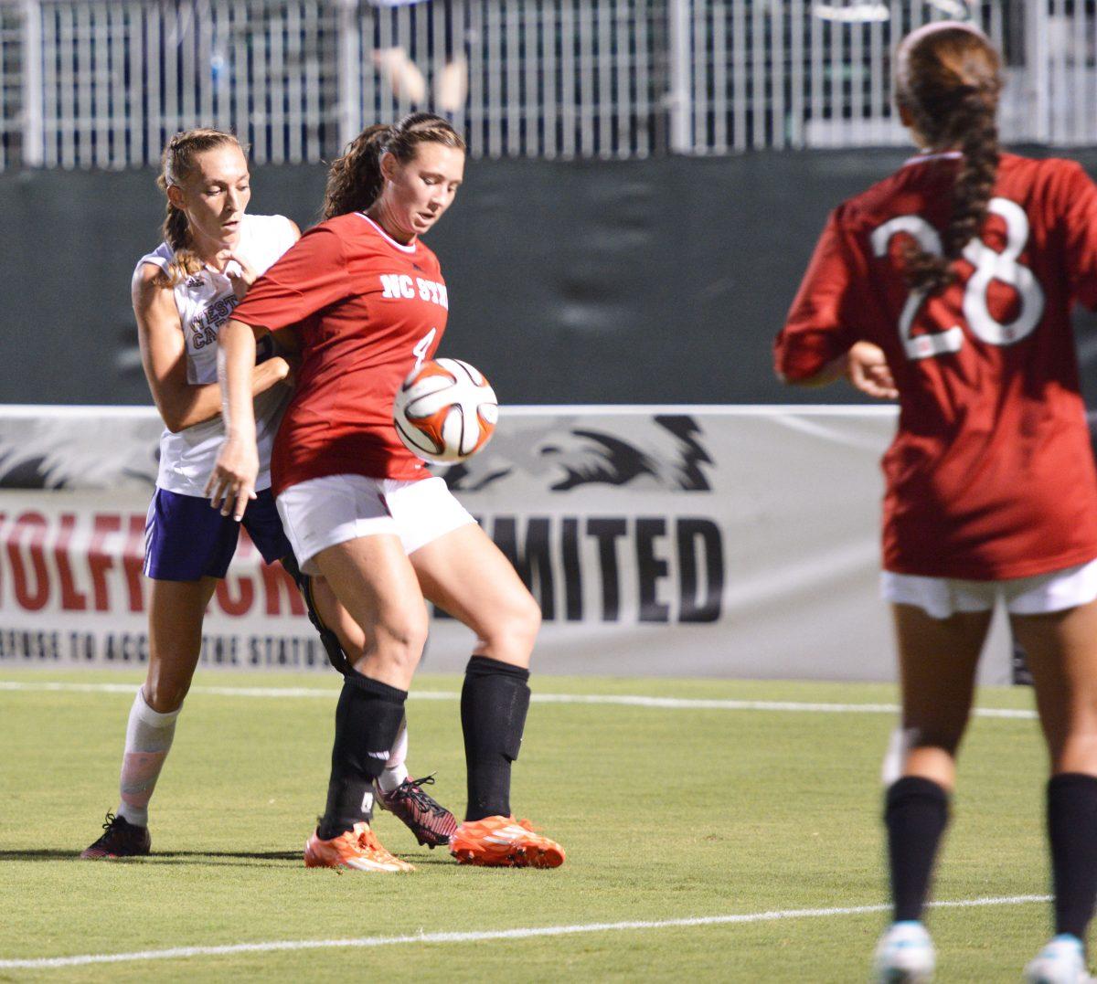 Freshman forward Kayla Saager manages to maintains control of the ball after a Wolfpack throw-in. State kept the lead for majority of the match, but allowed Western to score with around ten minutes to spare. Photo by Kristin Bradford