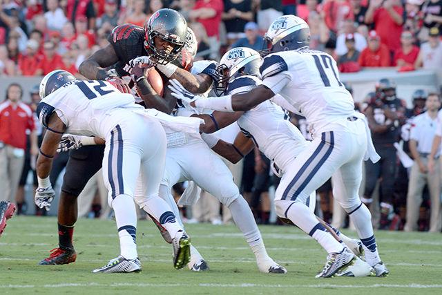 Junior runningback Shadrach Thornton fights through the defensive line during the game against Old Dominion Saturday. Thornton rushed for three touchdowns during the game. The Wolfpack defeated the Monarchs by a score 46-34, in a come-from-behind performance.