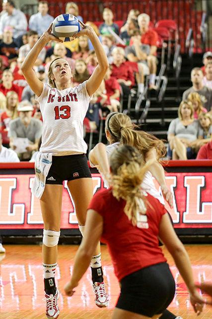 Sophomore Maggie Speaks sets the ball for a spike. The Wolfpack swept Syracuse 3-0 on Friday evening. Photo by Nick Faulkner