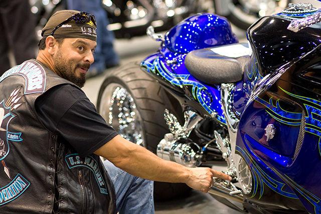 Domingo &#8220;Tazz&#8221; Torres checks out a custom motorcycle at Bikefest.&#160; Torres rode in from Jacksonville, North Carolina to attend Bikefest and represent his organization, Veteran Enforcers Motorcycle Association Sunday in the Raleigh Convention Center.