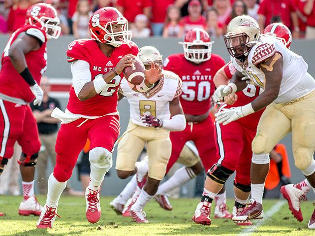 Redshirt junior Jacoby Brissett evades Florida State defenders while looking to throw downfield on Saturday. Brissett finished with 359 yards through the air and three touchdowns while also earning 38 yards on the ground. Despite the performance, NC State fell to the Seminoles 56-41.