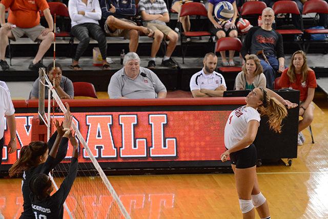 Senior oppsite Rachel Buckley spikes the ball against Coastal Carolina Friday Sept. 19 in Reynolds Colliseum. Buckley led the team in scoring with 13 kills. The Wolfpack defeated the Chanticleers 3-0. photo by Kai McNeil