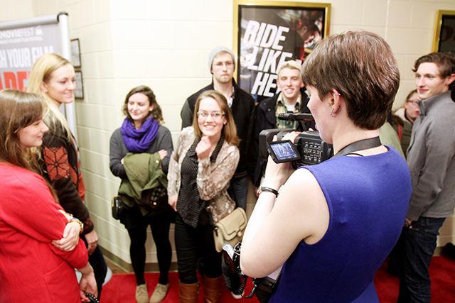 The first students in line on the red carpet are interviewed by CMF while waiting for the Saturday night premiere.