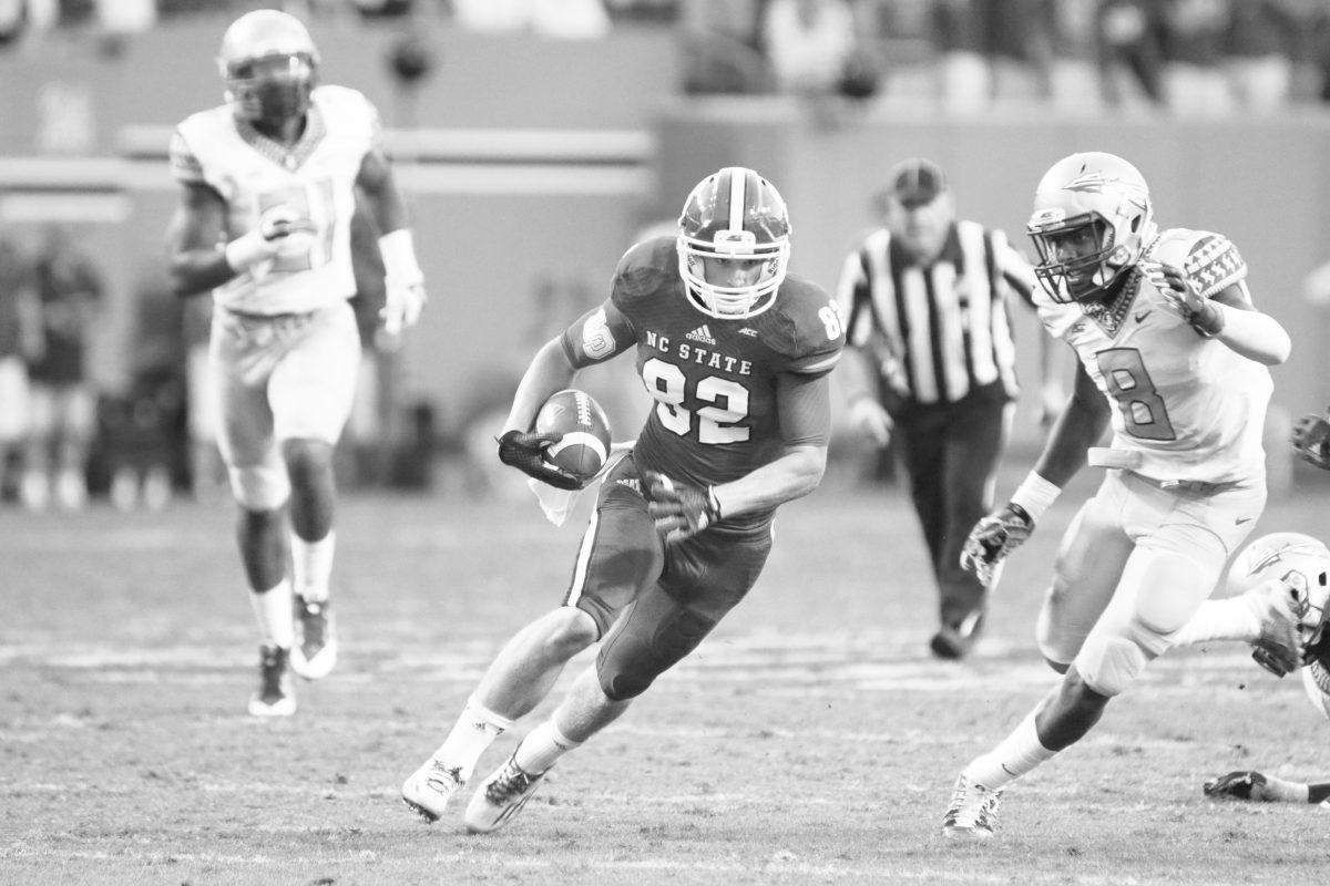 Freshman wide receiver Bo Hines carries the ball up the field against Florida State. Though the Wolfpack had 500 yards of offense, FSU pulled off the win 56-41 on Saturday, September 27th, 2014. Photo by Nick Faulkner