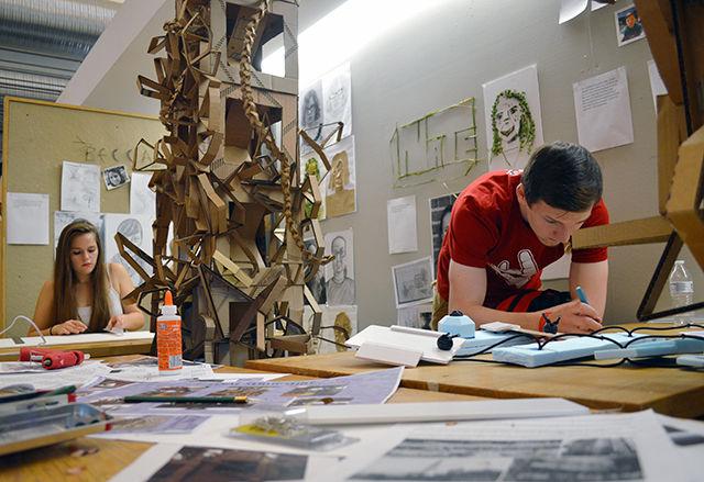First-year design students and group mates Carly Owens (left) and Nate Winskunas (right) combine their individual talents to complete their current assignment. &#8220;I switched from fashion management to art and design, because I wanted to be a part of a more studio-based program,&#8221; Owens said. &#8220;I really enjoy it! I have to spend a lot of time in the studio which I&#8217;m okay with, because it&#8217;s the kind of work that I want to do in the future.&#8221;