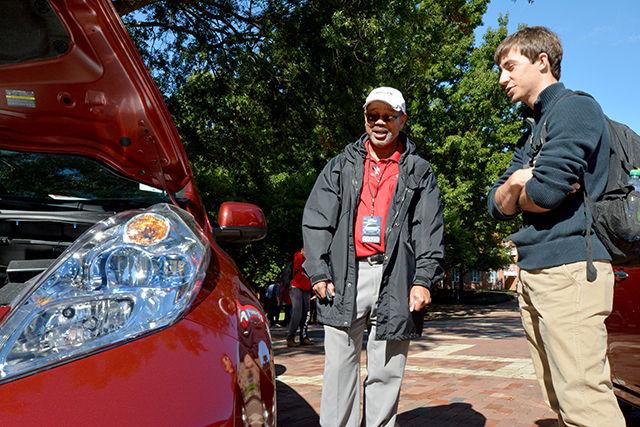 Derek Parker, a sales representative for Leith Nissan in Cary, and Justin Barker, a sophomore in civil engineering engage in a discussion about fuel-efficient cars next to a brand new Nissan Leaf 2015 model as part of the Alternative Vehicles showcase in the Brickyard Thursday. Barker was amazed at the number of dealers and cars represented and at the number of students that attended the event.