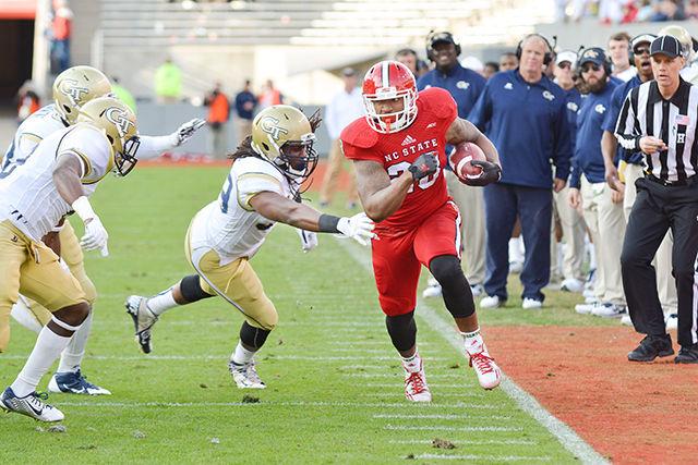 Freshman tight end/fullback Jaylen Samuels runs the ball down the sideline during the homecoming football game against Georgia Tech in Carter-Finley Stadium Saturday, Nov. 8, 2014. The Wolfpack's two season drought of home conference wins continued with a 56-23 loss to the Yellow Jackets.