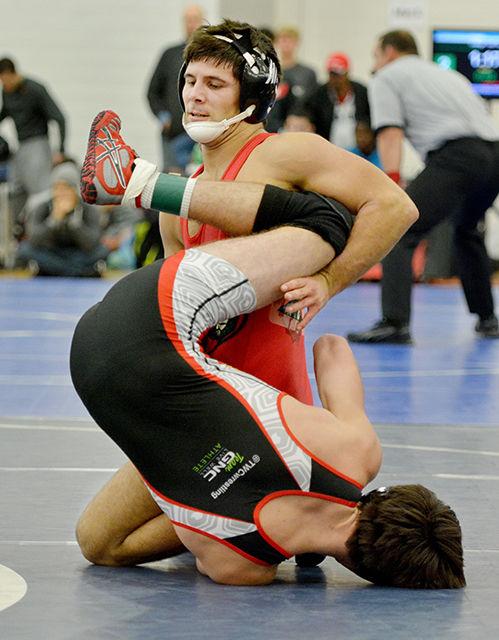 Redshirt freshman Beau Donahue flips opponent Matthew Pente (Maryland) during the Wolfpack Open Sunday morning, Nov. 16, 2014 at Carmichael Gymnasium. Donahue tied for 8th overall with teammate Jake DeAngelo in the 149 lb weight class.