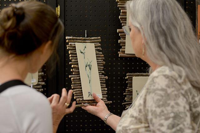 Artist Susan G. Luster (right) who specializes in botanically-themed pottery displayed her work at the 30th Annual Crafts Center Fair and Sale held in Thompson Hall on Saturday. The Fair drew a huge crowd and displayed a variety of artists from in and around Raleigh. "It's a great place to meet customers and sell," said Susan.