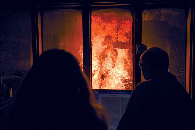 Sophomore in textile technology Jackie Halula watches a demonstation of the Pyroman system during a tour of the Textile Protection and Comfort Center Monday, Nov. 10, 2014. Researchers at T-PACC work on public and private research to analyze the performance of advanced textile materials and apparel. Pyroman is used to test how clothing responds to flames and resists heat.
