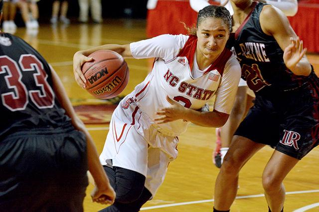Sophomore guard Miah Spencer scores drives past Brooke Robinson of Lenoir-Rhyne Friday at Reynolds Coliseum. Spencer led the Wolfpack, scoring 15 points. NC State struck victory against Lenoir-Rhyne with a final score of 70-52.