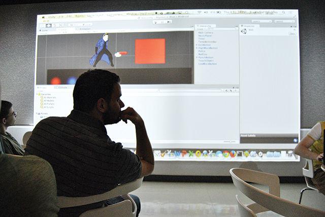 Austin Snider, a senior in computer engineering, watches a demonstration of Rhythm 'N Blue at a meeting of the Video Game Development Club on Thursday in the Creativity Studio at James B. Hunt Library. Rhythm N' Blue is one of four being developed this year by members of the club, which mostly consists of computer science and engineering students.