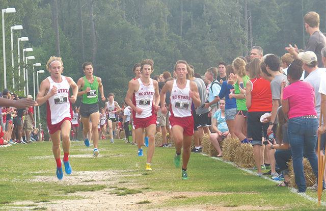 From left, NC State redshirt junior Graham Crawford, redshirt sophomore Sam Roberson and redshirt freshman Sebastian Hanson race at the Wolfpack Invitational Sept. 19. The NC State men&#8217;s and women&#8217;s cross country teams finished second and fourth, respectively, of 15 teams Friday, Oct. 31 at the 2014 ACC Cross Country Championships.