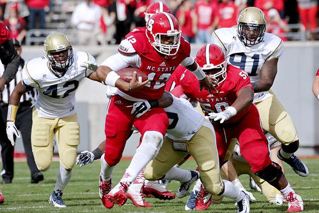 Redshirt junior quarterback Jacoby Brissett scrambles for yards against the Georgia Tech defense. Brissett averaged 8.6 yards per carry. The Yellow Jackets defeated the Wolfpack 56-23 Saturday.