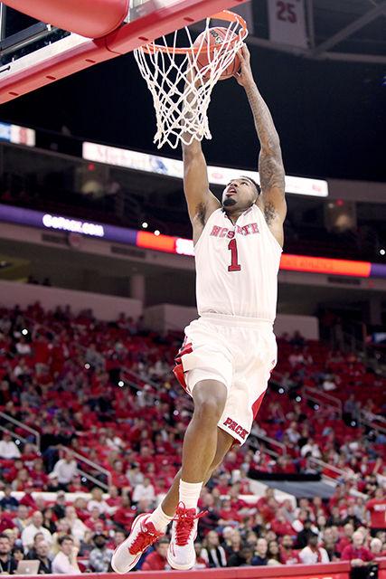 Redshirt junior guard Trevor Lacey dunks the ball during the exhibition game against Queens (N.C.) in PNC Arena Saturday, Nov. 8, 2014. Lacey had 7 points, 4 assists, and 3 steals in the Wolfpack's 78-47 victory over the Royals.