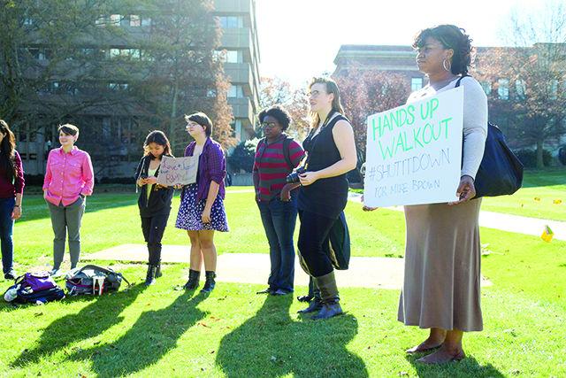 Students participate in the #HandsUpWalkOut Monday. The demonstration intended to promote awareness of police violence against minorities.