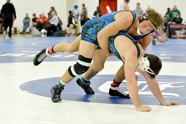 Sophomore Max Rohskopf grapples with opponent Garrett Peppelman (UVA-UNA) during the Wolfpack Open Sunday morning, Nov. 16 at Carmichael Gymnasium. Rohskopf finished 8th overall with in the 165 lb weight class.