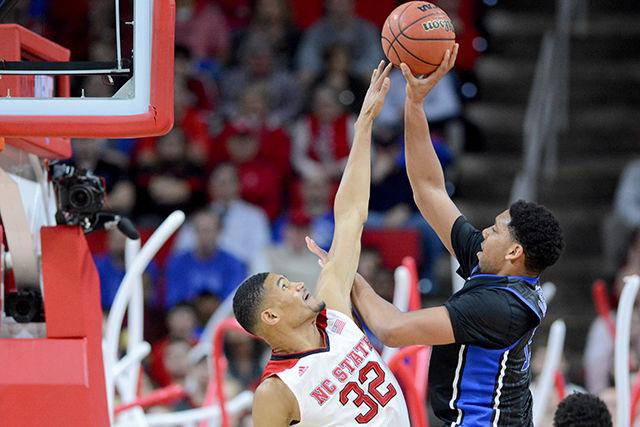 Sophomore forward Kyle Washington attempts to block a shot during the men's basketball game against No. 2 Duke in PNC Arena Sunday. Washington had nine points, three assists, and four blocks in the Wolfpack's 87-75 victory over the Blue Devils.