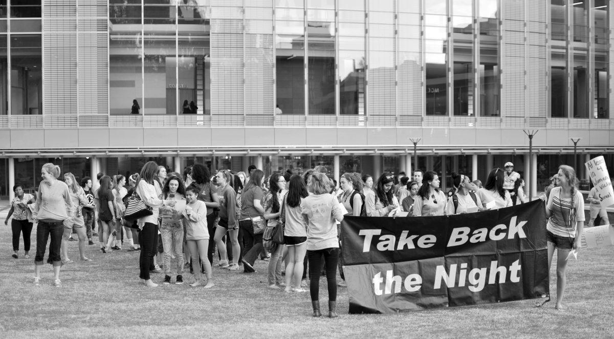 Students march and chant to raise awareness for sexual assault during Take Back the Night. The event was hosted by the N.C. State Women's Center and took place Thursday, April 10 in Stafford Lawn outside of Talley. Photo by Elizabeth Davis