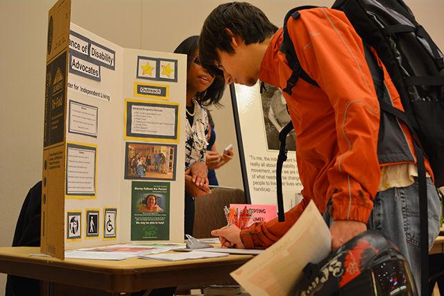 Arthur Freeman, a sophomore studying philosophy, signs an interest sheet for the Alliance of Disability Advocates at the Volunteer Career Fair in Talley Ballroom Wednesday.&#160; The Alliance of Disability Advocates is helps people with disabilities to live independently.&#160; Since Freeman liked the idea of independence as a concept and wanted to explore how they help people, he was attracted to the venue.&#160; &#8220;I love the notion that disability as defined from the perspective of the disabled, whether they feel limited in life,&#8221; Freeman said.