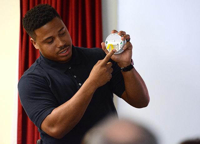 Timothy McCoy, a member of the Durham Fire Department talks about smoke detectors to volunteers on Saturday. This event, organized by the American Red Cross Society, was meant to spread awareness about fire safety to residents in downtown Raleigh.