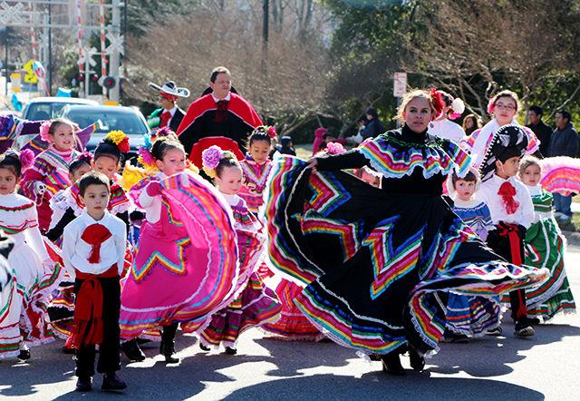 Representing Mexico, a group of small dancers playfully walk through the center of Cary at the Three Kings Day parade on Saturday.