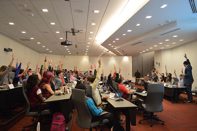 Student Senate President Cody Long advises the Student Senate body to &#8220;raise [their] hands as high as [they] could.&#8221;