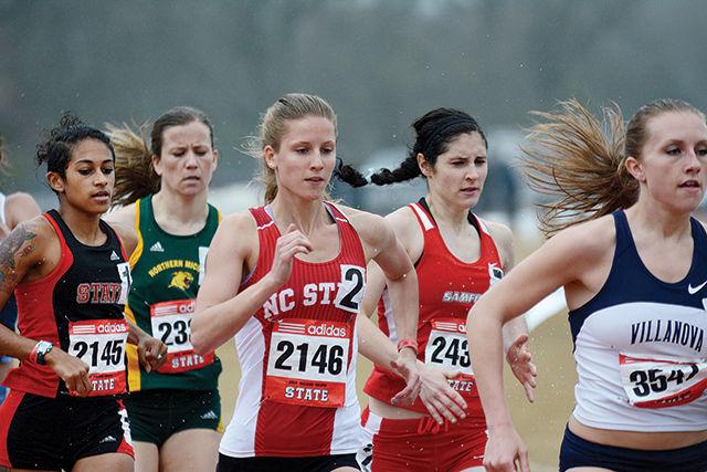 Red shirt Megan Moye and red shirt Ryanna Henderson run their second lap of the women's 200 meter dash. Megan and Ryanna finished in fifteenth and ninth place. The 2014 Raleigh Relays were held at Dale Soccer Field Friday and Saturday. Photo by Joseph Phillips
