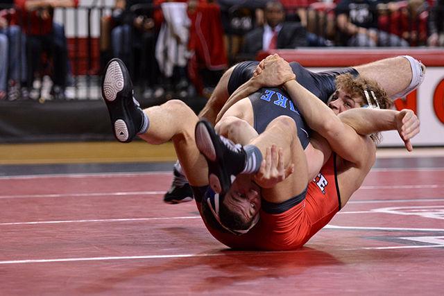No. 15 Sophomore Max Rohskopf grapples with Duke's Jake Faust during the 165 lb. weight class bout Wednesday evening, Jan. 7, 2014 in Reynolds Coliseum. Rohskopf dropped the bout 3-2. The Wolfpack narrowly lost to the Blue Devils 18-17 after No. 17 Sam Speno (141 lb.) was downed by decision by Duke's Evan Botwin 6-4.