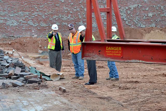 Construction workers on Hillsborough Street talk about their work at the site formerly home to Two Guys Pizza and The Keg on Jan. 6.