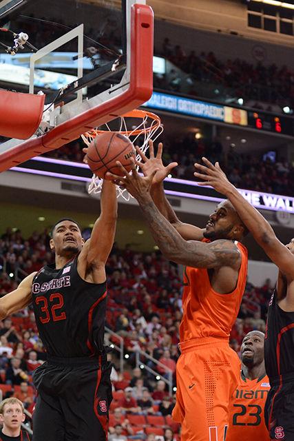 Freshman forward Kyle Washington reaches for a rebound during the game against Miami in PNC Arena Mar. 1, 2014. The Wolfpack fell to the Hurricanes, 85-70. Photo by John Joyner.