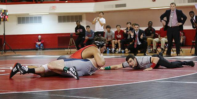 Redshirt junior Nick Gwiazdowski pins Pitt's Ryan Solomon to the floor. Gwiazdowski won the match in a blazing 1:56. NC State beat No. 14 Pittsburgh 27-12 during the Beauty and the Beast matchup.
