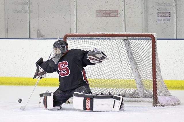Goalkeeper Nick Kamaris stops a puck sent flying by UNC-Chapel Hill. The Wolfpack held the Tar Heels to two goals during a 6-2 win at the Raleigh IcePlex Nov. 7, 2014. The team is currently 14-7-2 overall and 8-1-0 in the ACC.