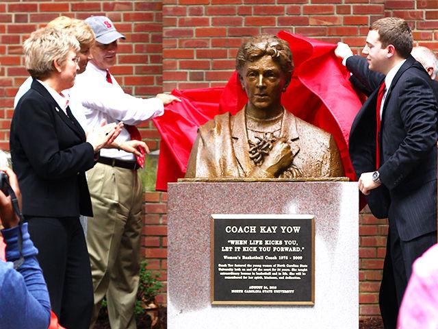 Family members Susan Yow, Debbie Yow and Ronnie Yow, along with Jeffery Johnson, a senior in business administration, and Jim Barnhill, sculptor of the memorial, unveil the memorial for Kay Yow beside Reynold's Coliseum Tuesday, Aug. 24, 2010.
