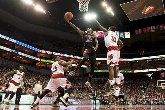 Sophomore guard Anthony 'Cat' Barber drives through the lane against multiple Louisville defenders during Saturday's game.