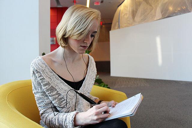 Mackenzie Raymond, freshman studying English, checking and finishing off the notes she took during a class while on an assignment for Disability Services Office. DSO uses technology such as Livescribe to make it easier and faster for academic assistants to take and send notes to the students registered at the DSO.