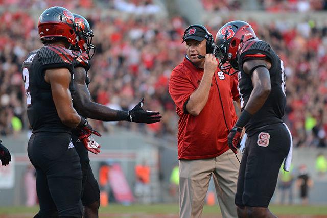 Head coach Dave Doeren talks to his players during a break in play in the game against Old Dominion Sept. 6, 2014. The Wolfpack defeated the Monarchs, 46-34.